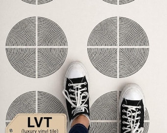 May include: Black and white sneakers on a floor with a repeating circular pattern. The pattern consists of concentric black lines within a circle, bisected by a white line. The text "LVT (luxury vinyl tile) 1,5 mm thickness" is visible.
