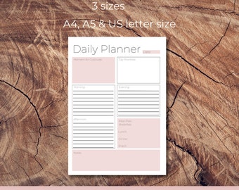May include: A printable daily planner with sections for gratitude, top priorities, morning, afternoon, evening, meal plan, notes, and a date field. The planner is available in three sizes: A4, A5, and US letter. The text "Digital Download" is at the bottom of the page.