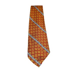 May include: A necktie featuring a repeating geometric pattern of yellow and red diamond shapes. The design is accented by two diagonal stripes that run across the fabric, each containing a series of small blue and white floral motifs.