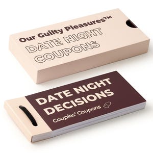 May include: A light tan box and a dark maroon booklet with the text "Our Guilty Pleasures DATE NIGHT COUPONS" and "DATE NIGHT DECISIONS Couples' Coupons" in white. The booklet has a black cord for easy access.