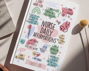 May include: A white notebook with the words "Nurse Daily Affirmations" and various affirmations in colorful text. The notebook includes illustrations of a stethoscope, thermometer, and other medical-related icons. The name "Emily, RN" is also printed on the cover.
