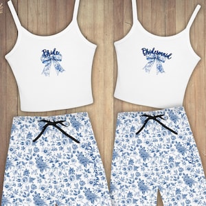 May include: Two white tank tops with blue floral print bows and the words "Bride" and "Bridesmaid" printed on them. Matching blue and white floral print pajama pants with the words "Bride" and "Bridesmaid" printed on the legs.