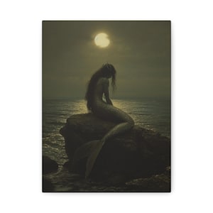May include: A rectangular canvas print featuring a dark, moody scene of a mermaid with long flowing hair sitting on a large rock in the middle of the ocean. A bright, glowing full moon hangs in the dark, cloudy sky above the calm, reflective water.