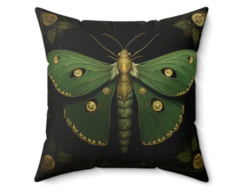 May include: A green and gold moth with large, iridescent eyes on a black background. The moth is surrounded by small, gold-coloured leaves.