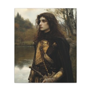 May include: A young person with long dark hair wearing a black cloak and gold armour stands by a river in a forest. The person is looking off to the side.