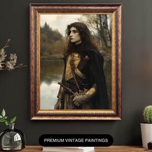 May include: A vintage painting of a person in armour standing in a forest by a river. The person is wearing a dark cloak and a golden breastplate. The painting is framed in a dark wood frame with gold accents.