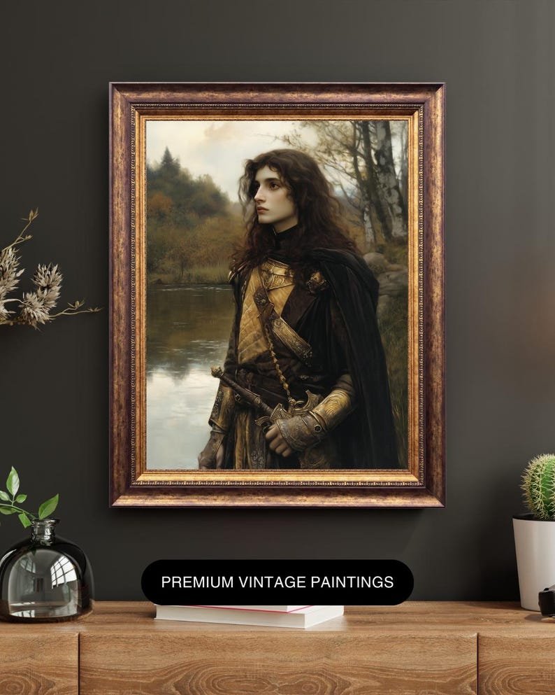 May include: A vintage painting of a person in armour standing in a forest by a river. The person is wearing a dark cloak and a golden breastplate. The painting is framed in a dark wood frame with gold accents.