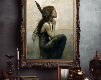 May include: A framed painting of a young girl with a mermaid tail, wearing a crown and a seashell necklace. The girl is sitting on a rock in the ocean, looking out at the horizon. The painting is in a dark, ornate frame.