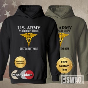 May include: Black and green hooded sweatshirt with the text "U.S. ARMY VETERINARY CORPS" and a gold medical symbol. The sweatshirt also has the text "CUSTOM TEXT HERE" and a gold seal that says "Available in Sweatshirt".