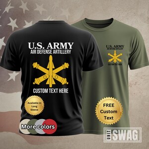 May include: Black and olive green t-shirts with the text "U.S. ARMY AIR DEFENSE ARTILLERY" and a gold emblem. The black shirt has "CUSTOM TEXT HERE" and a gold seal that says "Available in Long Sleeve" and "More colors". The olive green shirt has a gold seal that says "FREE Custom Text".