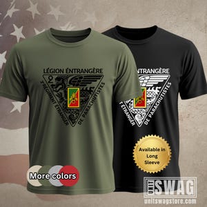 May include: Two short-sleeved t-shirts, one olive green and one black, featuring a triangular emblem with text in French. The emblem includes a dragon, wings, and the words "Légion Étrangère" and "2e Régiment Étranger de Parachutistes". The black shirt has a gold sticker that says "Available in Long Sleeve".
