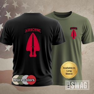 May include: Black t-shirt with a red and black Airborne patch featuring a dagger. The t-shirt is available in long sleeve. The text "More colors" is below the t-shirt. The text "Available in Long Sleeve" is on a gold starburst sticker. The text "UNIT SWAG" is on a gold sticker.