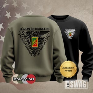 May include: Two sweatshirts, one olive green and one black, featuring a triangular emblem with text in French: "LÉGION ÉTRANGÈRE", "2º RÉGIMENT ÉTRANGER", and "DE PARACHUTISTES". The emblem includes a crest with a dragon and a shield. The black sweatshirt has a smaller emblem. The text "More colors" and "Available in Hoodie" are also visible.