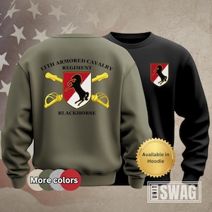 May include: Green sweatshirt with the text "11th Armored Cavalry Regiment Blackhorse" and a black horse graphic. The sweatshirt is available in hoodie style.