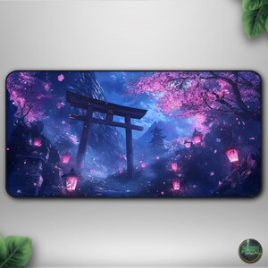 May include: A rectangular mousepad featuring a digital illustration of a Japanese landscape. The design includes a torii gate, cherry blossoms, and glowing lanterns in shades of purple and pink against a dark blue sky.