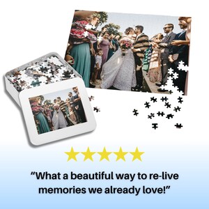 May include: A white box containing a wedding photo jigsaw puzzle. The puzzle is partially assembled and shows a bride and groom kissing with guests surrounding them. The box has a black and white photo of the same wedding scene on the front.