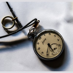 Lying Pocket Watch with Leather Cord. Digital posters.