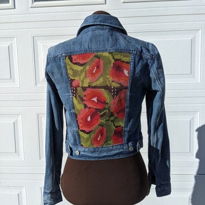 Flowery Guatemalan huipil on jean jacket