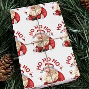 May include: White wrapping paper with a repeating pattern of Santa Claus illustrations and the text "HO HO HO".