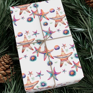 May include: White gift wrap with a repeating pattern of colorful starfish and sea urchins. The starfish are outlined in black and have a variety of colors, including pink, orange, yellow, and blue. The sea urchins are a mix of purple, pink, and orange.