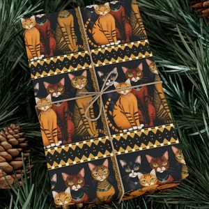 May include: Black gift wrap with a repeating pattern of orange, brown, and black cats wearing gold collars and sitting in a row. The cats are on a black background with a gold geometric pattern.