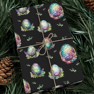 May include: Black wrapping paper with a repeating pattern of iridescent dragon eggs on a black background. The eggs are surrounded by green leaves and flowers.