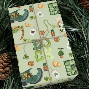 May include: Green and gold wrapping paper with a St. Patrick's Day theme. The paper features a repeating pattern of shamrocks, gold coins, leprechaun hats, and the word "LUCK".