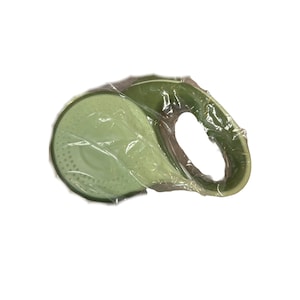 May include: A green retractable dog leash with a handle and a plastic casing. The leash is wrapped in plastic.