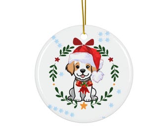 May include: A round white ceramic Christmas ornament with a cartoon puppy wearing a Santa hat and a red bow. The ornament has a gold hanging string and is decorated with a green wreath and red stars.