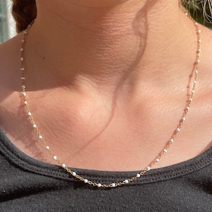 gold necklace with white dots