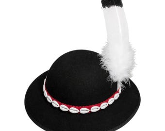 May include: A black hat with a rounded crown and a wide brim. The hat is decorated with a red band adorned with white shell-like beads. A large white feather with a black tip is attached to the side of the hat.
