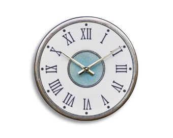 Handmade Raku ceramic wall clock with Roman numerals and a light blue background - 29 cm diameter