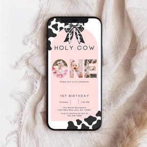 May include: A pink and white cow-print themed first birthday invitation with a photo of a baby girl in a pink dress. The invitation says "Holy Cow I'm One" and includes the date, time, and location of the party.