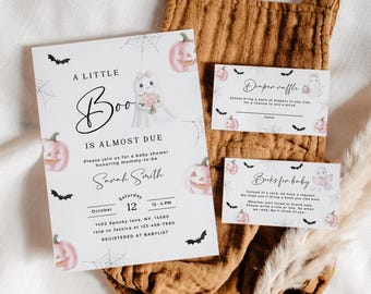 May include: Halloween-themed baby shower invitation set. The main invitation features a ghost holding flowers, pumpkins, and bats. Includes a diaper raffle card and a book request card. The design is on a white background.