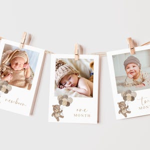 May include: Three photo cards with a baby in different stages of growth. Each card features a brown teddy bear holding balloons and the text "newborn", "one month", and "two months".