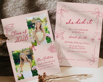 May include: Pink graduation announcement cards with a photo of a graduate. The cards feature the text "Class of 2026" and "she did it". The announcement includes details about the graduation ceremony, including the date, time, and location.