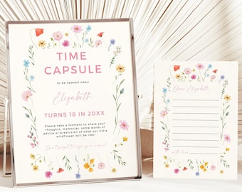 May include: A white card with a floral border and the text "Time Capsule" in pink. The card also includes the text "to be opened when Elizabeth turns 18 in 20XX".  The card is in a silver frame. A second white card with a floral border and the text "Dear Elizabeth" is also shown.