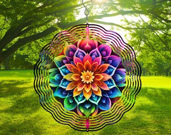 May include: A colorful metal wind spinner with a mandala design. The spinner features a large, multi-colored flower with intricate details. The wind spinner is suspended from a hook and is designed to rotate in the wind.