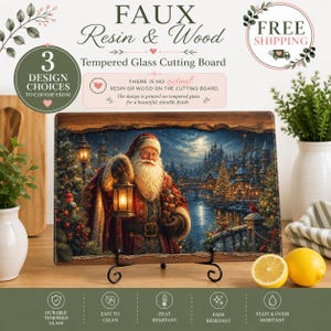 May include: A rectangular tempered glass cutting board featuring a printed image of Santa Claus holding a glowing lantern in a snowy village at night. The board has a faux wood grain border and is displayed on a black metal stand.