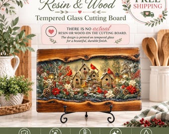 May include: A rectangular tempered glass cutting board featuring a printed design of wooden birdhouses, red cardinals, pinecones, and poinsettias. The board has a faux wood grain border and rests on a black metal stand, displaying a winter scene.