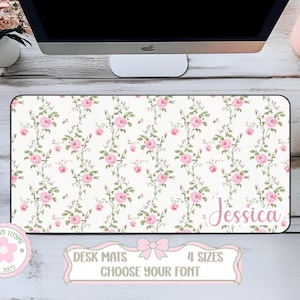 May include: A rectangular desk mat featuring a repeating pattern of pink roses and green leaves on a white background. The name Jessica is printed in a pink script font in the bottom right corner. The mat has a black border around the edges.