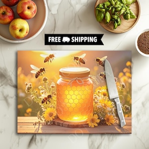 May include: A decorative cutting board featuring a jar of honey with a honeycomb design, surrounded by bees and yellow flowers. A knife rests on the board. The words "FREE SHIPPING" are displayed above the board.