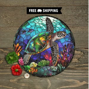 May include: A round cutting board with a stained glass design of a sea turtle swimming in the ocean. The turtle is green, blue, and yellow, and the ocean is blue and green. There are coral reefs and other sea life in the background.