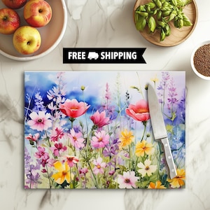 May include: A watercolor painting of a field of wildflowers in shades of pink, yellow, and purple. The flowers are arranged in a random pattern, and the background is a soft blue.
