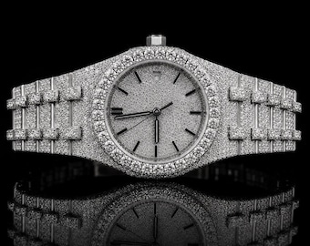 May include: A silver-toned wristwatch fully encrusted with small, clear, sparkling stones. The watch features a round dial with a textured, glittery surface, thin hands, and a matching link bracelet, all covered in dense, reflective stone settings.