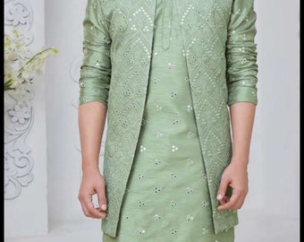 May include: A sage green kurta with a matching waistcoat, both featuring intricate mirror work embroidery. The outfit is paired with sage green pants.