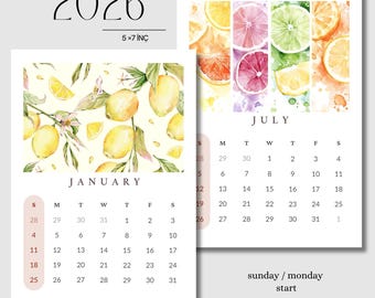 May include: A 2026 calendar with a watercolour design. The calendar features a lemon branch illustration for January and citrus fruit slices for July. The calendar is 12.7 x 17.8 cm.