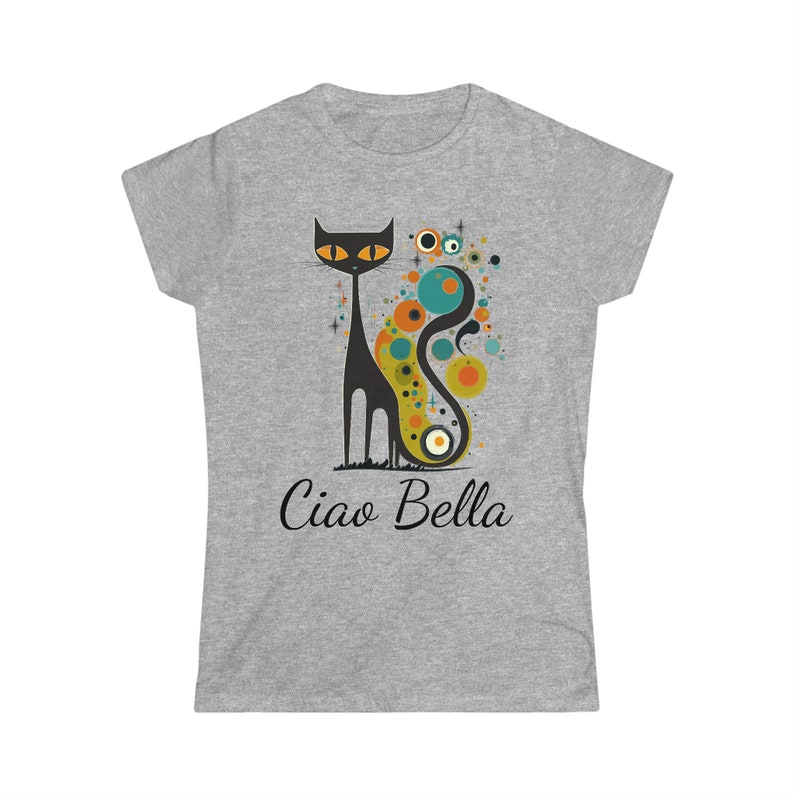 May include: A gray t-shirt featuring a stylized black cat with orange eyes and a long, curved tail. The cat is set against a backdrop of colorful circles and the words "Ciao Bella" are printed below the cat.