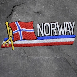 May include: Embroidered patch featuring the word "NORWAY" in white block letters. The patch includes a red, white, and blue design with the Norwegian flag. A yellow pole and tassels are on the left side.