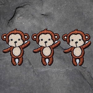 May include: Three brown embroidered monkey appliques with white faces and arms outstretched.